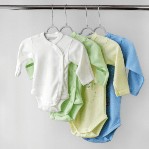 Bbay clothes hanging from a pole