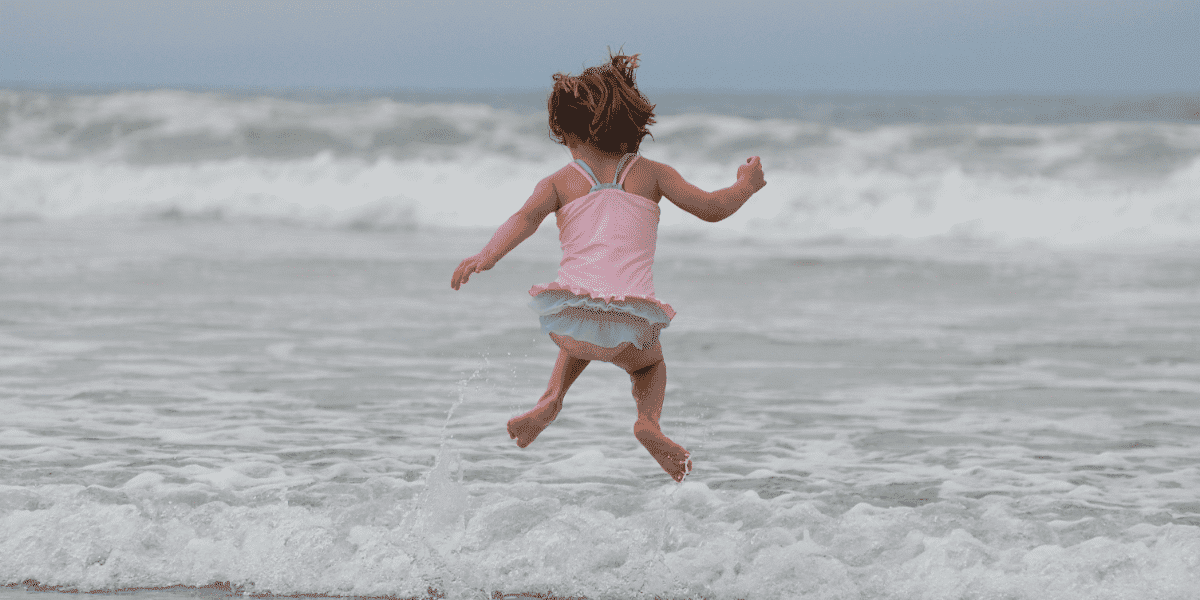 child jumping on the waves