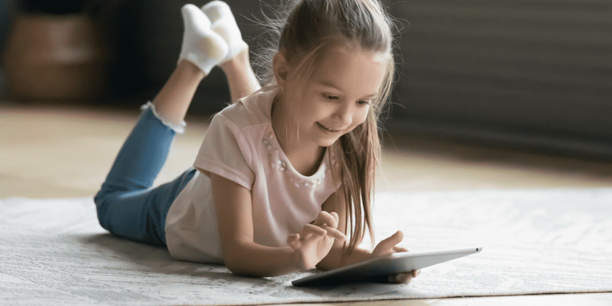 girl with tablet on the floor