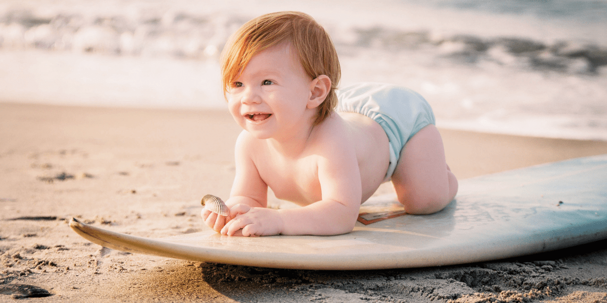 baby on a surf at the beach