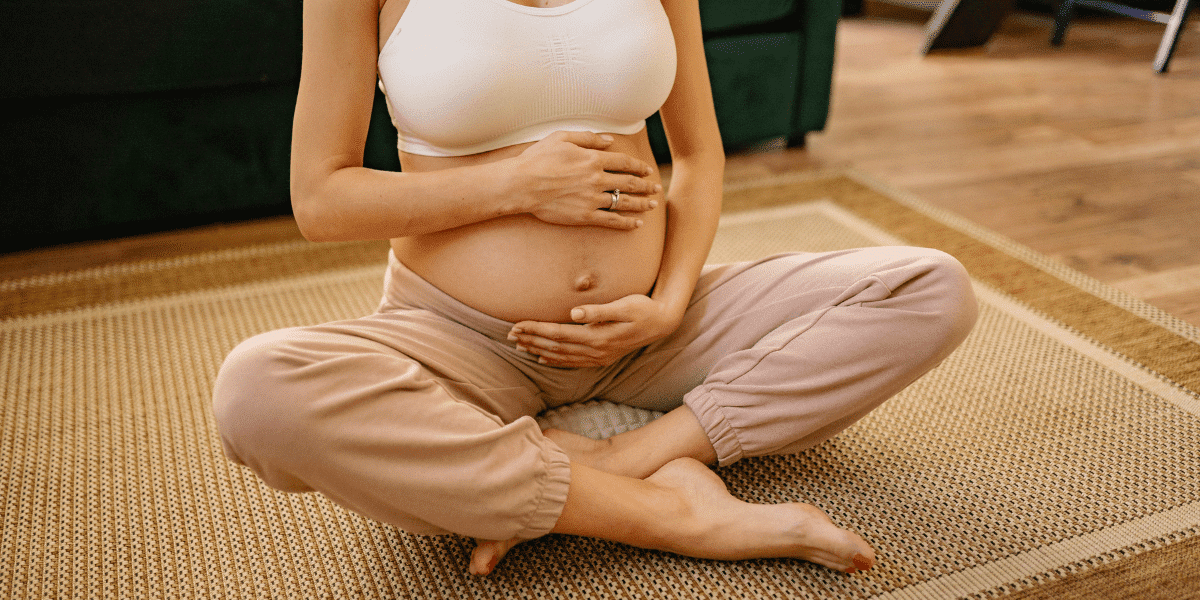 pregnant woman sitting cross legged