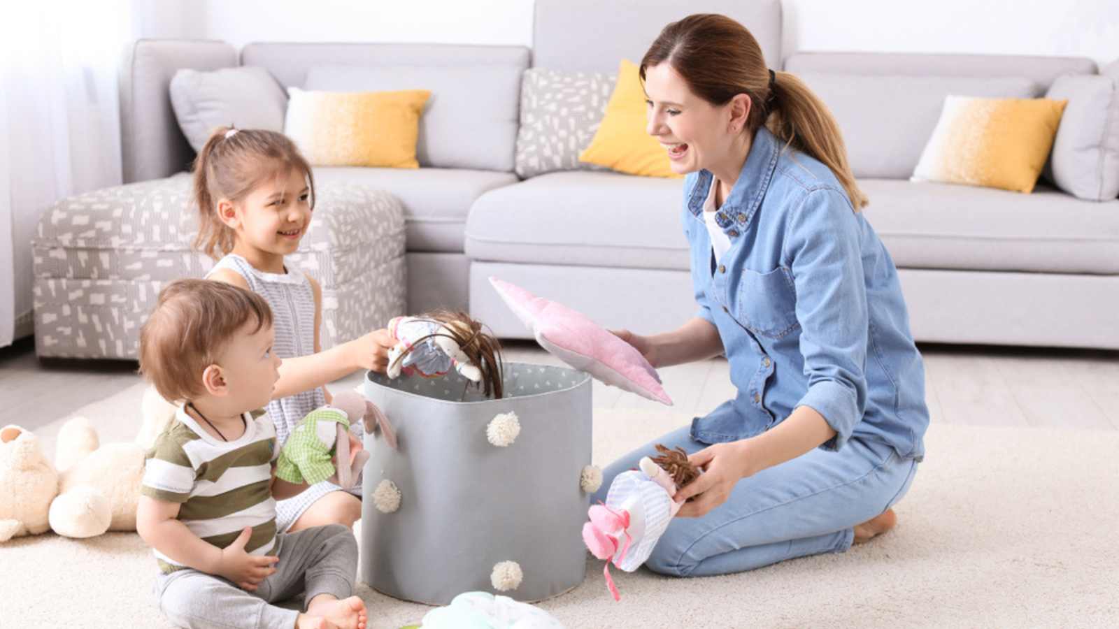 Parent helping child to put toy inside box